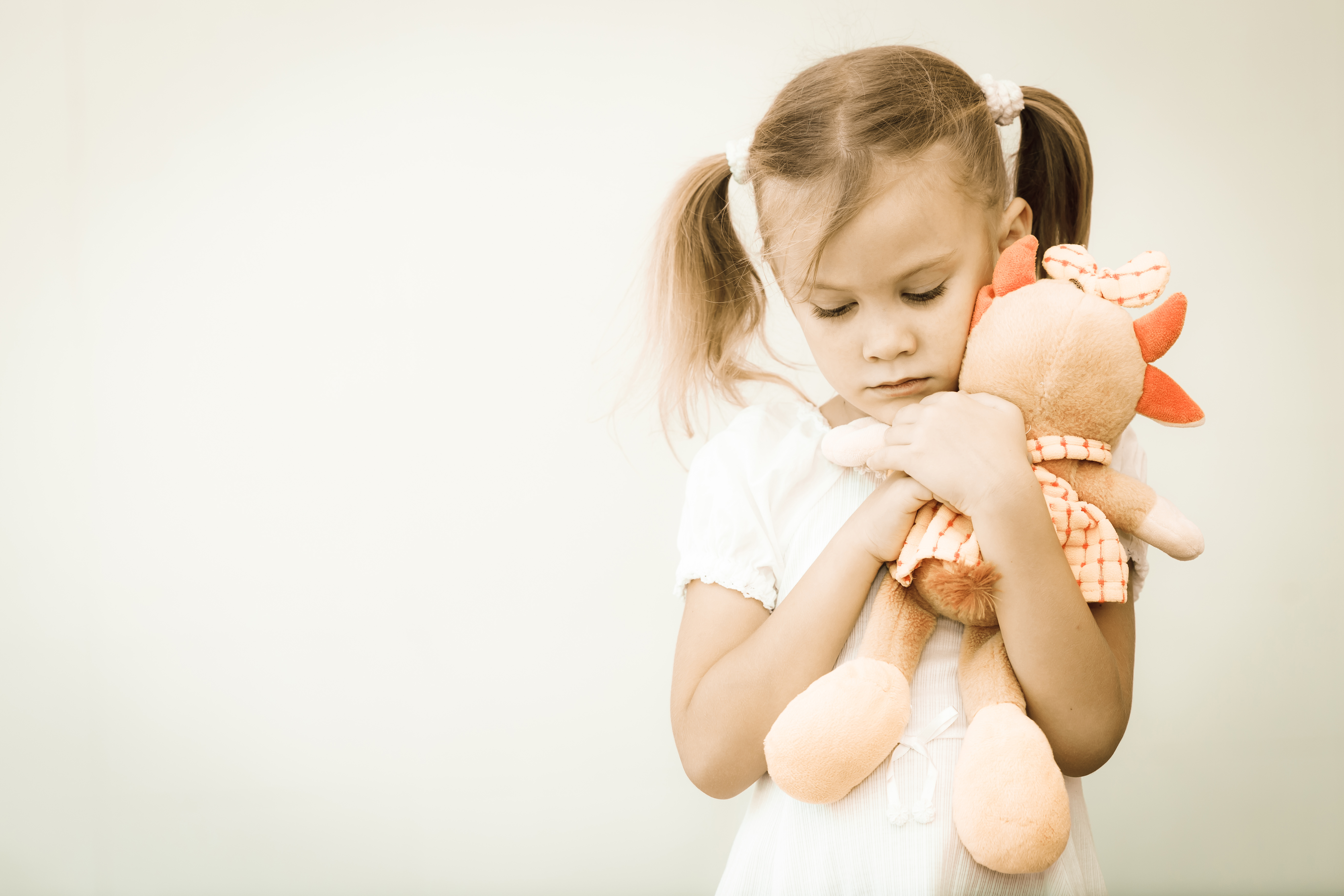 sad child with stuffed animal