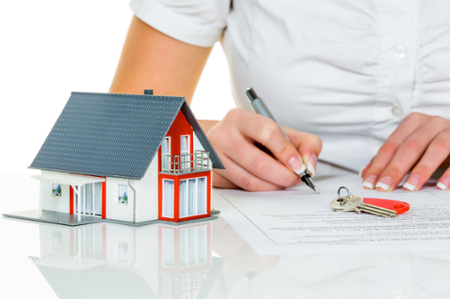 woman signing housing paperwork